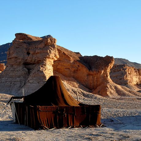 Blick auf ein dunkles Zelt im Wuestencamp Akka Naid Sidi