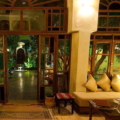 Blick auf ein Sofa im Innenbereich mit Blick auf den Garten des Riad Salama