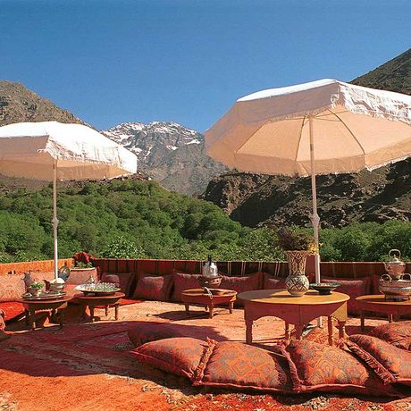 Blick auf Sitzmoeglichkeiten und Tische auf der Terrasse des Kasbah-Hotels du Toubkal