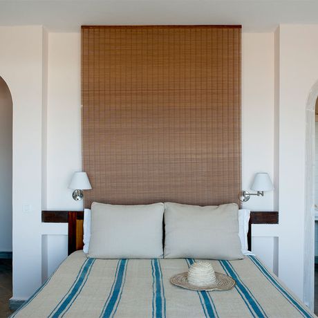 Blick auf ein Bett im Schlafbereich des Superiorzimmers Voyage mit Gartenblick