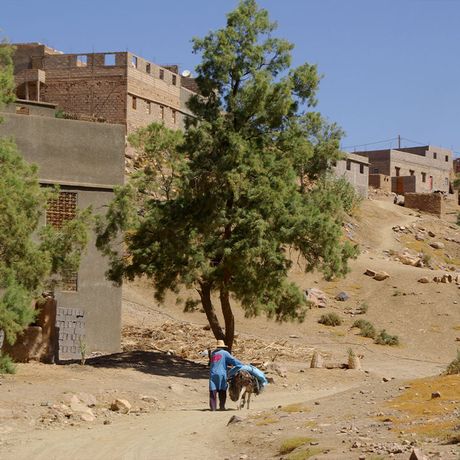 Blick auf eine Person mit einem Maultier in einem Dorf in Marokko
